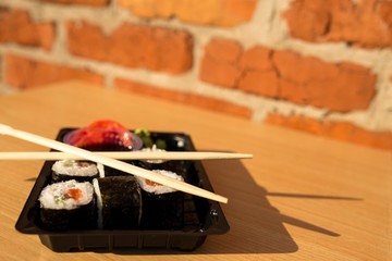 Sushi in plastic box. Lifestyle sushi with copy space