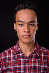 Obraz premium Face of young handsome Indian hipster man