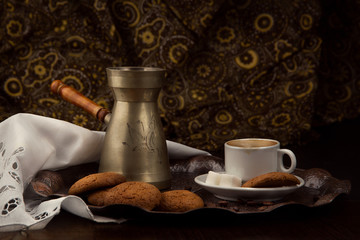 a Cup of coffee and a pot of coffee on a tray