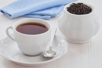 black tea in a Cup and teapot on a white background