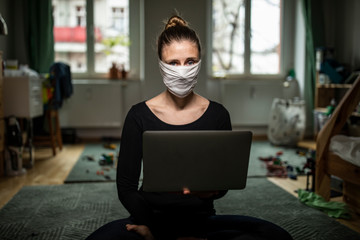 Woman with a mask in home office during Corona Virus time