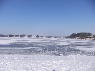 Animal tracks across a frozen lake