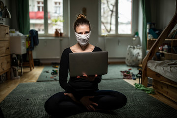 Woman with a mask in home office during Corona Virus time