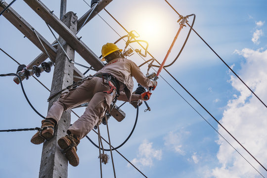 The power lineman use clamp stick (insulated tool) to closing a transformer on energized high-voltage electric power lines. The power lineman must be trained because it is a risky job.