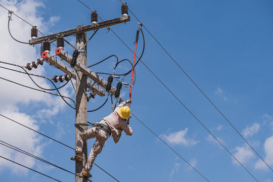 The power lineman use clamp stick (insulated tool) to closing a transformer on energized high-voltage electric power lines. The power lineman must be trained because it is a risky job.