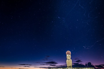 Ahu Ko Te Riku moai with eyes in Rapa Nui at night with bug trails