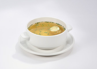 chicken soup with egg and greens on a white background