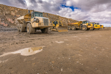 Large trucks in an open pit mine