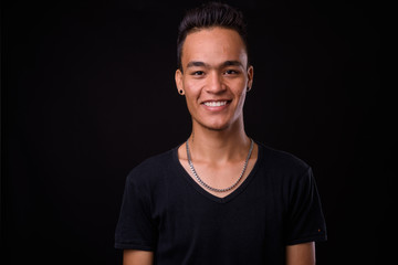 Face of happy young handsome Indian man smiling