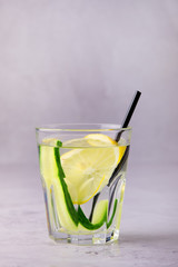 Glasses of Healthy Detox Water with Lemon and Cucumbers Diet Drink Straw Vertical