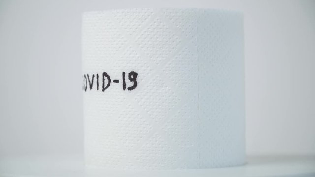 Toilet paper with text covid-19. Concept of lack of toilet paper in stores due to coronavirus. Covid-19, hygiene, panic