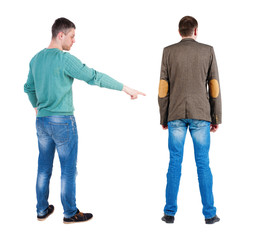 Back view of two man in sweater pointing.