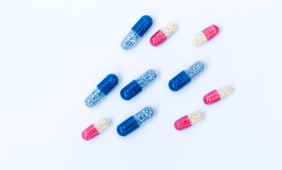 Heap of colorfull pills, tablets, capsules on white background. Drug prescription for treatment medication health care concept wth copy space.