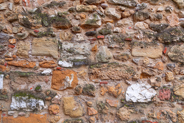 Texture of antique masonry wall. Texture of a stone wall. (Multi-colored bricks)