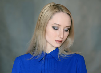 Fototapeta premium Portrait of beautiful young woman with blue eyes. Studio shot.