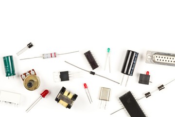 Different electronic parts or components on white with resistors, capacitors, diode and ic chips,...