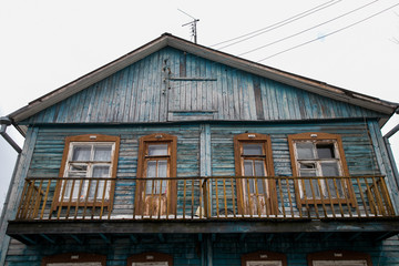 dilapidated housing, resettlement house on the background of a new house under construction