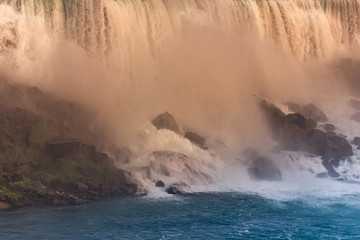 Close-up of the waterfall on the U.S. side at sunset. Concept of nature and travel. Niagara Falls, Canada. United States of America