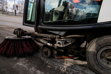 Street cleaner vehicle on the road collecting garbage and junk with brush rotation and vacuum hoover