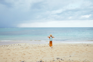 Fototapeta na wymiar young woman running on the beach