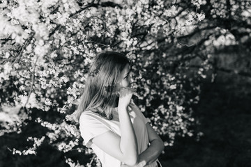 monochrome photo of beautiful girl in spring garden during coronavirus pandemic