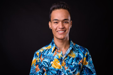 Portrait of happy young Indian tourist man smiling