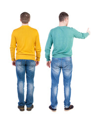 Back view two man in sweater showing thumb up.