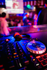 Fototapeta na wymiar DJ Spinning, Mixing, and Scratching in a Night Club, Hands of dj tweak various track controls on dj