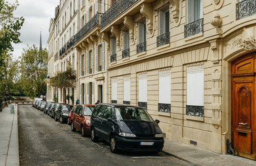 Fototapeta na wymiar Typical old Paris architecture and deserted streets with no tourists while citizens stay at home in self isolation. Residential buildings facades, expensive real estate concept, economy crisis