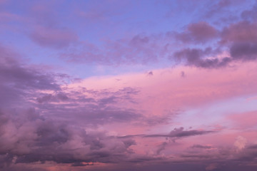 Dramatic sunrise, sunset pink blue violet sky with clouds background texture