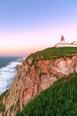 Fototapeta na wymiar Cabo da Roca, Sintra, Portugal. Lighthouse and cliffs over Atlantic Ocean, the most westerly point of the European mainland at sunset.