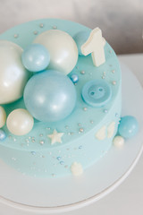 Birthday blue cake for the first year of the baby. Accessories for parties Flat lay, side view.