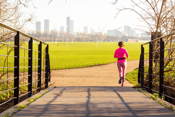 Social distancing - jogging alone in the park near Hackney Marshes, London