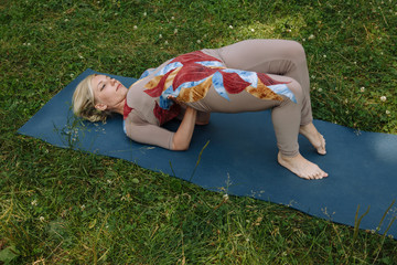 Variation of ardha chakrasana half wheel pose by woman in gymnastic costume. Working out yoga excercise Half Wheel Pose