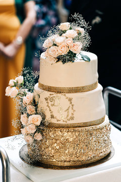 Wedding Cake Three Tiers White Gold With Flowers Roses And Stand On A White Background