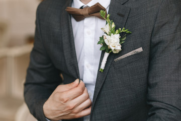 classic dark man’s jacket on a man, hands, details, butterfly, blazer