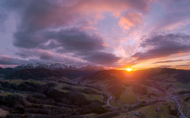 Fototapeta premium Sunset over the Austrian Alps after a Rainy day in February, with snow on the mountain tops