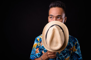 Portrait of young handsome Indian tourist man