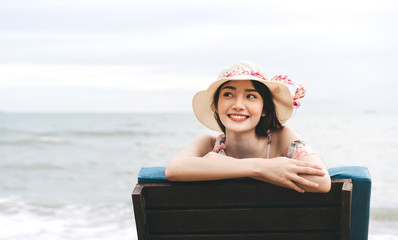 Happy asian travel woman relax at the beach on summer holiday. © dodotone