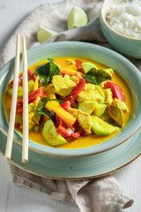 Spicy yellow curry with kaffir leaves, coconut milk and chicken