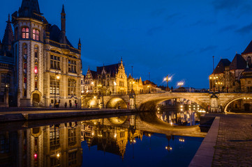 Fototapeta na wymiar Ghent, Flemish Region / Belgium - april 24 2012 : St Michael’s Bridge and old post office at night in Ghent, Belgium