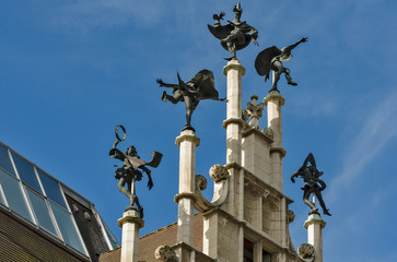 Fototapeta na wymiar Ghent, Flemish Region / Belgium - april 24 2012 : On top of the stepped gable of theMasons’ Guild Hall. six dancers turn merrily with the wind in Ghent, Belgium