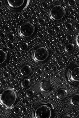 Abstract background of water drops big and small on a transparen