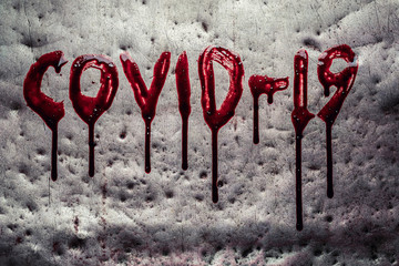 Covid19 word painted by dripping blood on metal