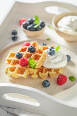Sweet and tasty waffles with fresh blueberries and raspberries