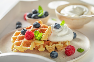 Homemade and tasty waffles with fresh blueberries and raspberries