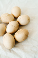 Seven Easter eggs trendy pastel colored with cracks lie on the table on a light tablecloth. top view. minimal style. easter concept.copy space for text