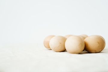 Seven Easter eggs trendy pastel colored with cracks lie on the table on a light tablecloth. minimal style. easter concept.copy space for text