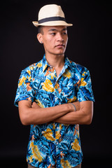 Portrait of young handsome Indian tourist man
