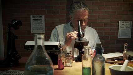 A scientist during the 1918 influenza pandemic working in his private laboratory searching for a cure to the Spanish Flu.